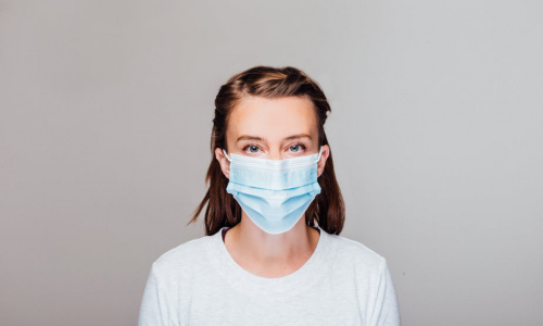 woman-in-grey-sweater-wearing-disposable-face-mask