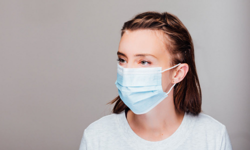 portrait-of-a-woman-wearing-disposable-face-mask