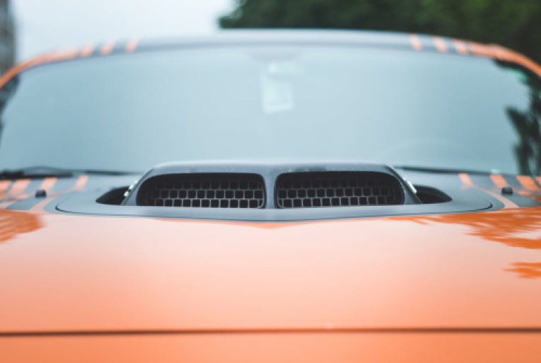 black-intake-on-orange-sports-car