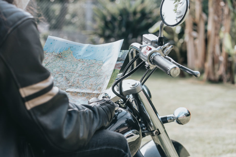 persons-torso-on-a-motorbike-holding-a-map