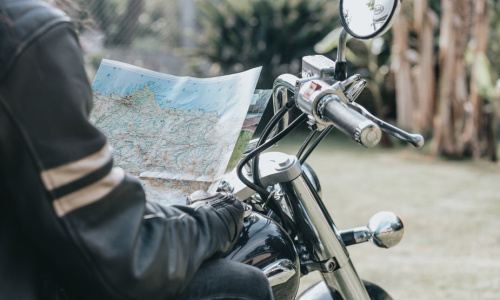 persons-torso-on-a-motorbike-holding-a-map