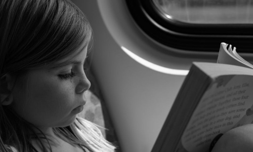 young-girl-reading-on-train