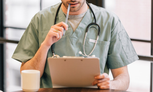 doctor-looking-at-clipboard