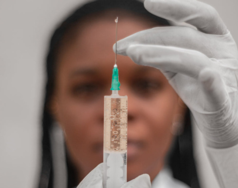 person-wearing-white-gloves-prepares-a-needle