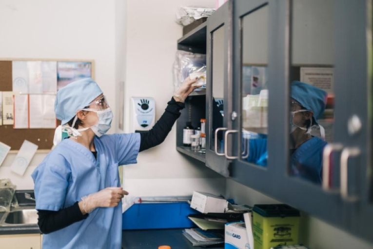 burst-partners-doctor-reaches-towards-shelf