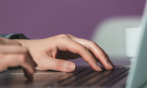 closeup-hands-on-laptop