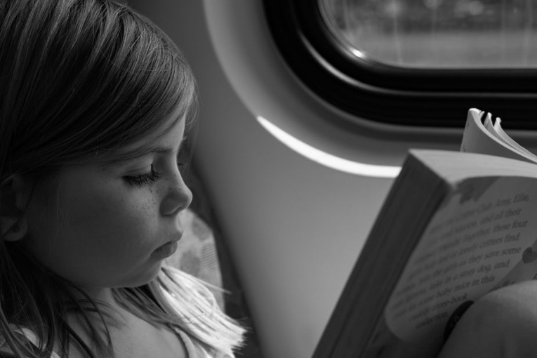young-girl-reading-on-train